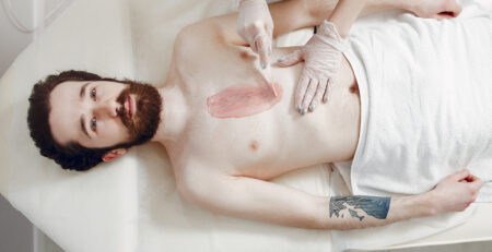 Man getting professional haircut at male grooming salon near me