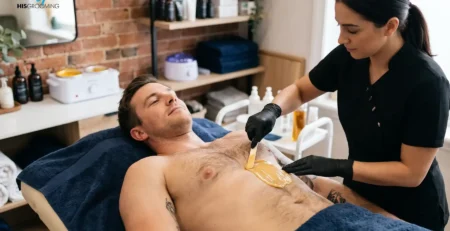 Therapist applying wax to a man's chest, avoiding common waxing mistakes men make